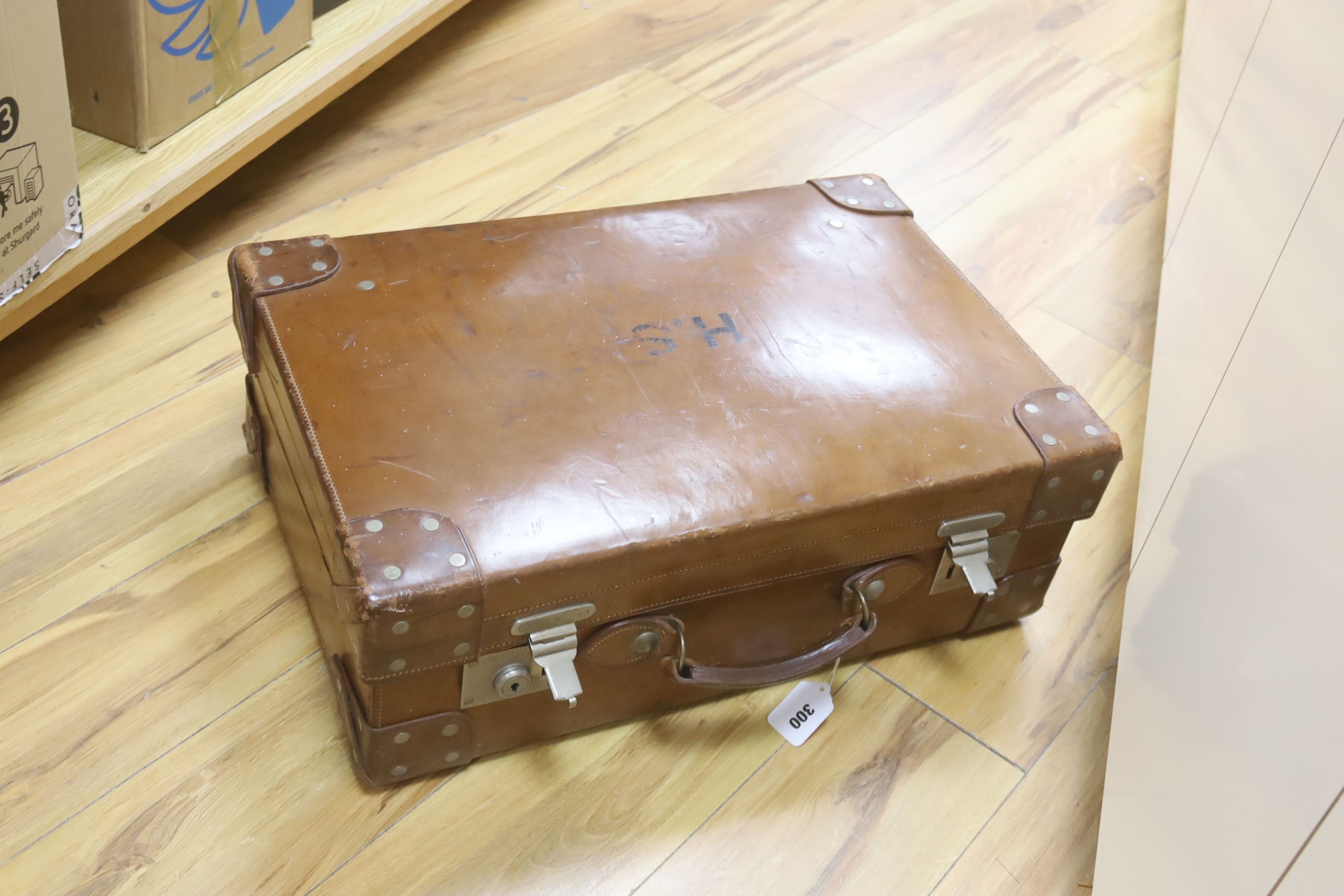 A gentleman's brown leather cased silver travelling vanity set, with silver lidded bottles interior, initialled HS